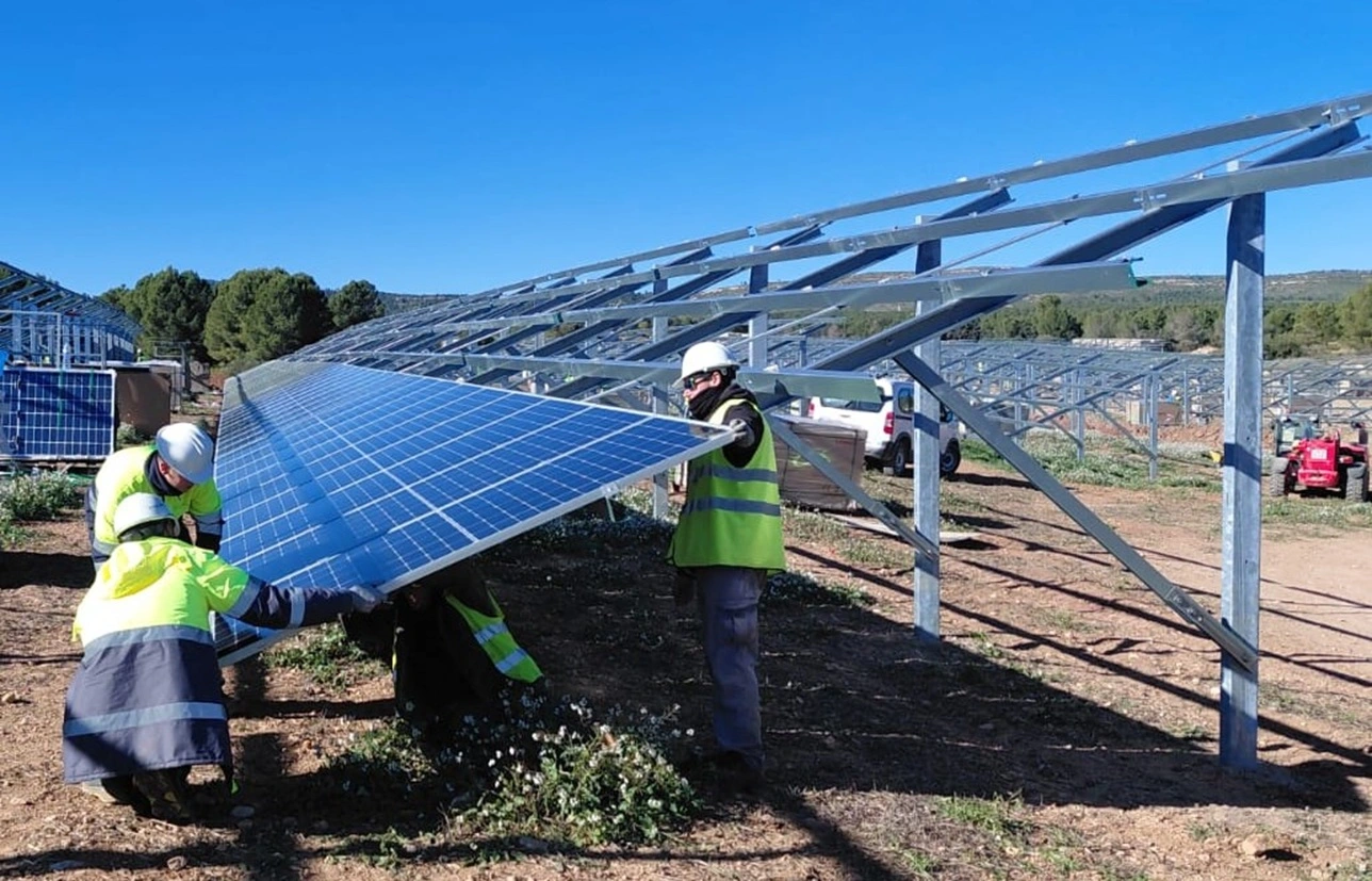 Workers assembling solar panels